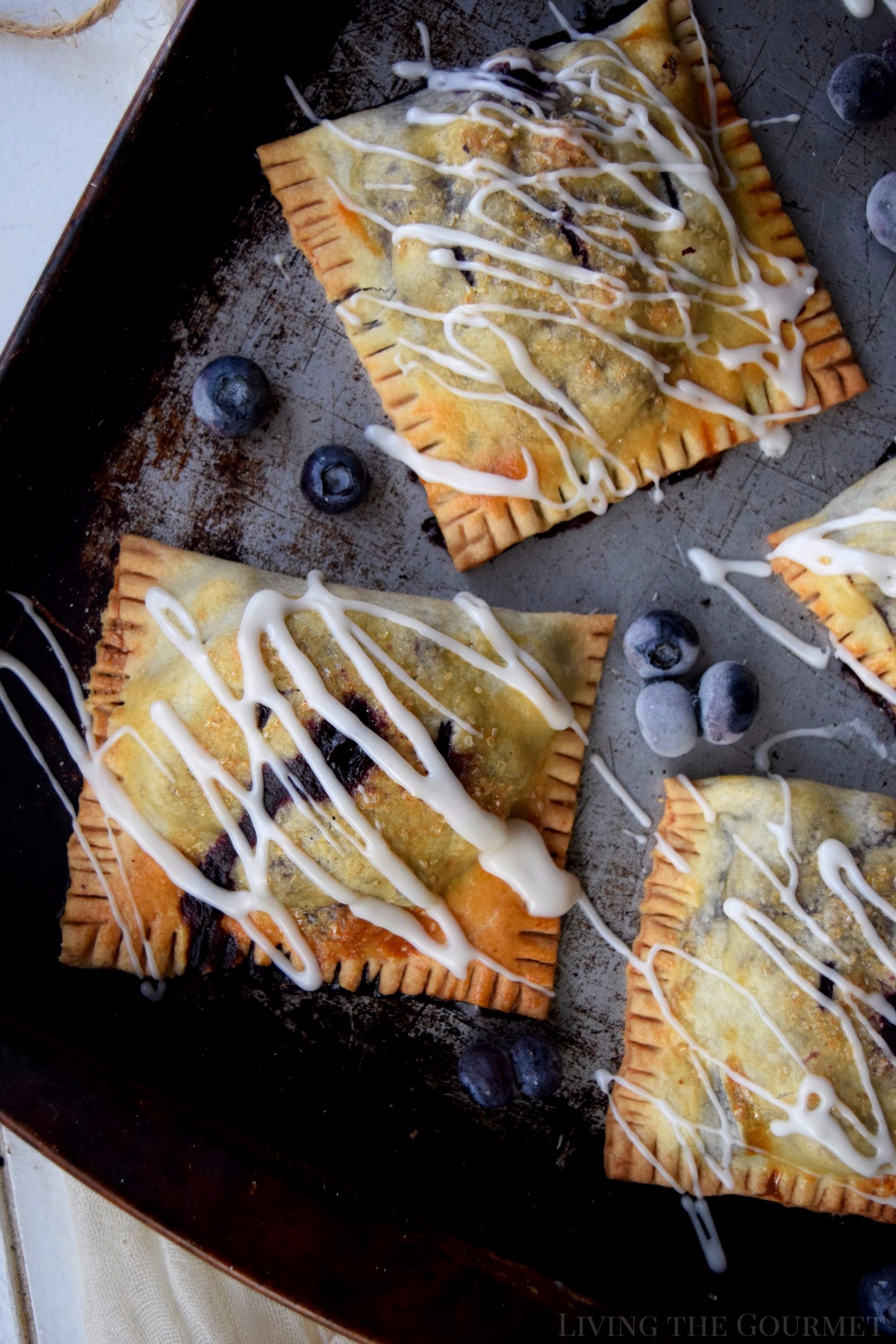 Living the Gourmet: Baked into a delicate, buttery crust, these Blueberry Basil Hand Pies are bursting with the flavors of the summer.