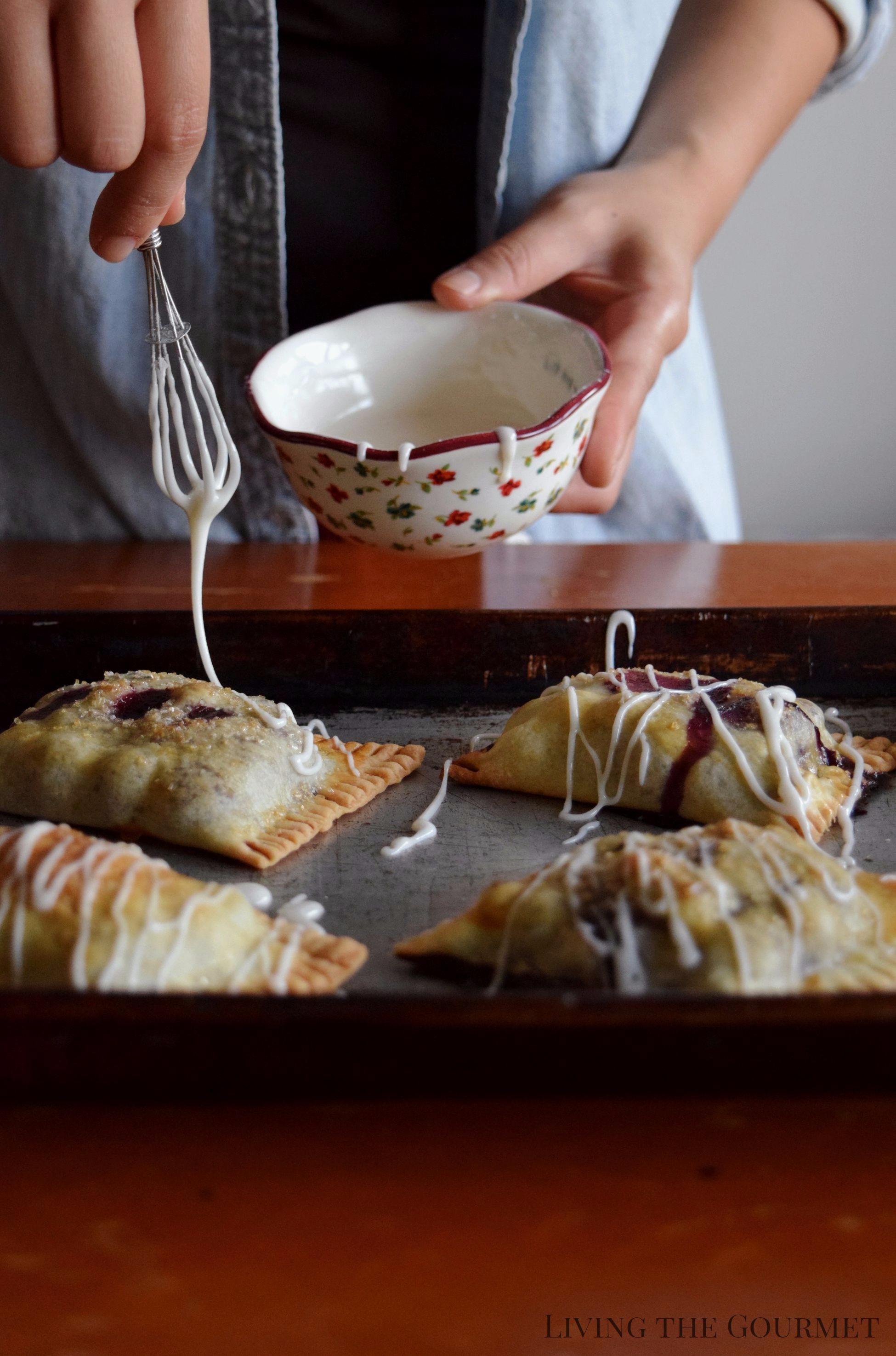 Living the Gourmet: Baked into a delicate, buttery crust, these Blueberry Basil Hand Pies are bursting with the flavors of the summer.