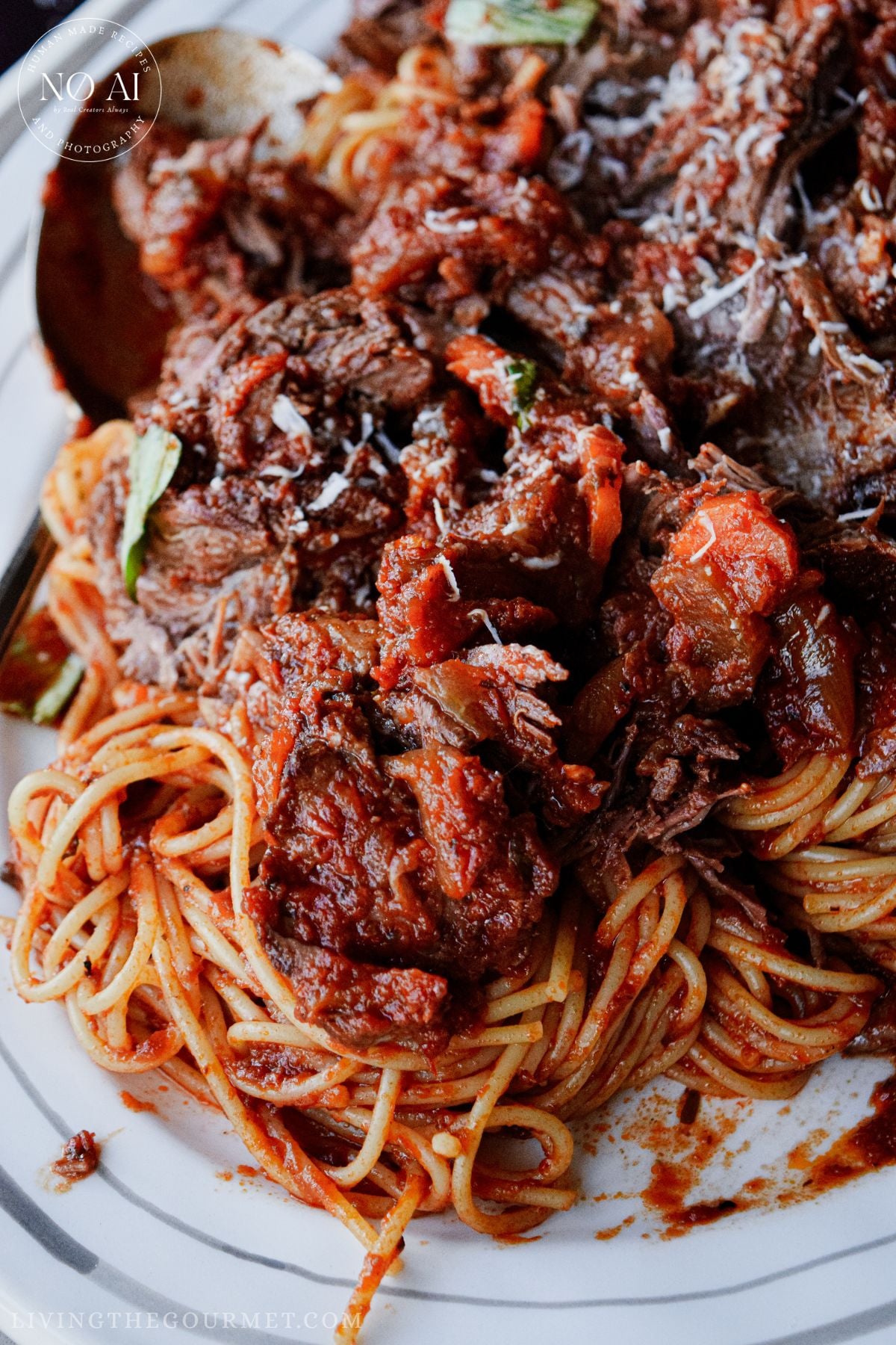 Oven Baked Chuck Roast served with spaghetti and fresh basil