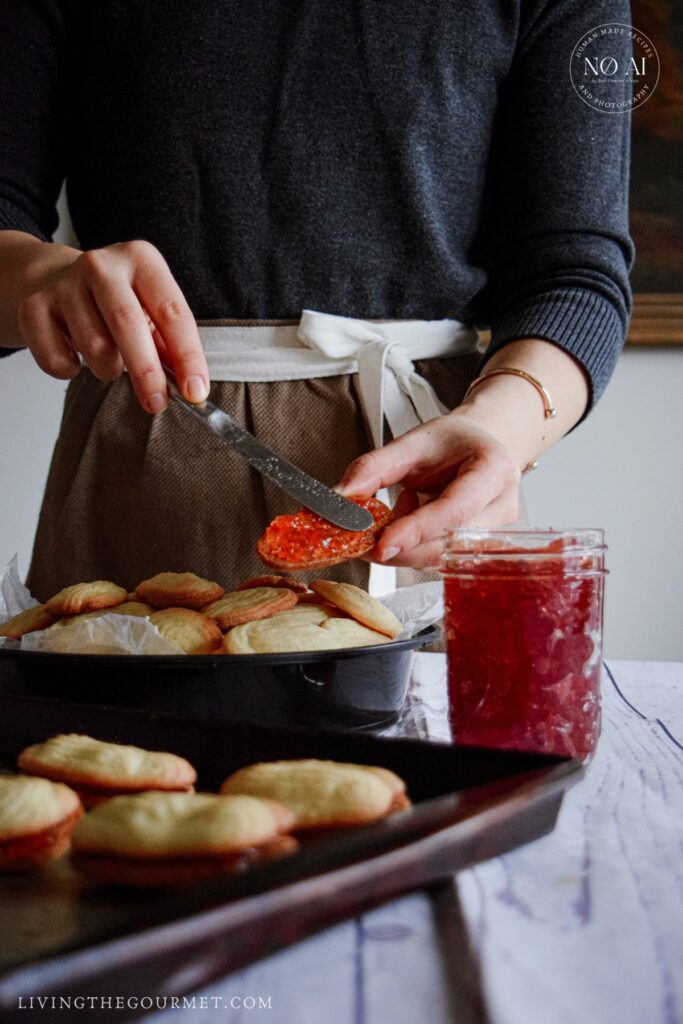 Sandwiching the cookies with strawberry jam