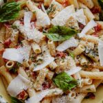 Pasta tossed with fresh basil, bacon, and grated cheese