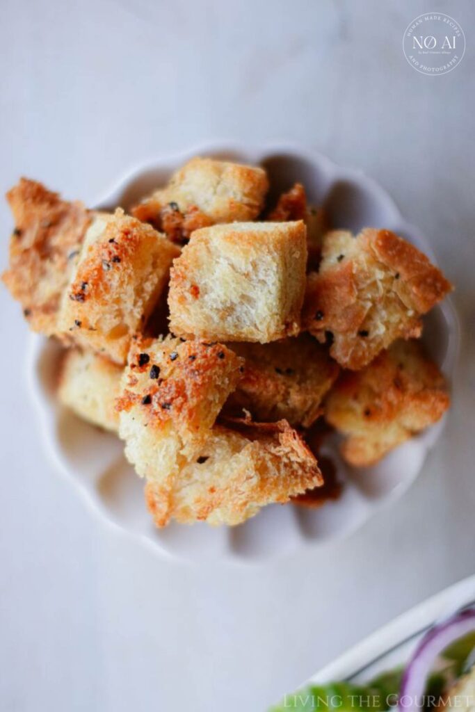 Make your own croutons at home with day-old bread, grated cheese, some seasonings, and a drizzle of olive oil!
