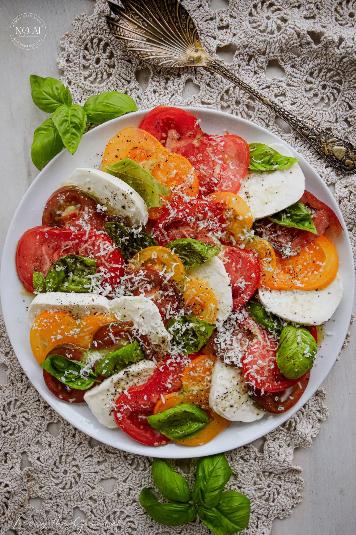 Drizzling extra virgin olive oil over stacked layers of mozzarella, tomato, and fresh basil.