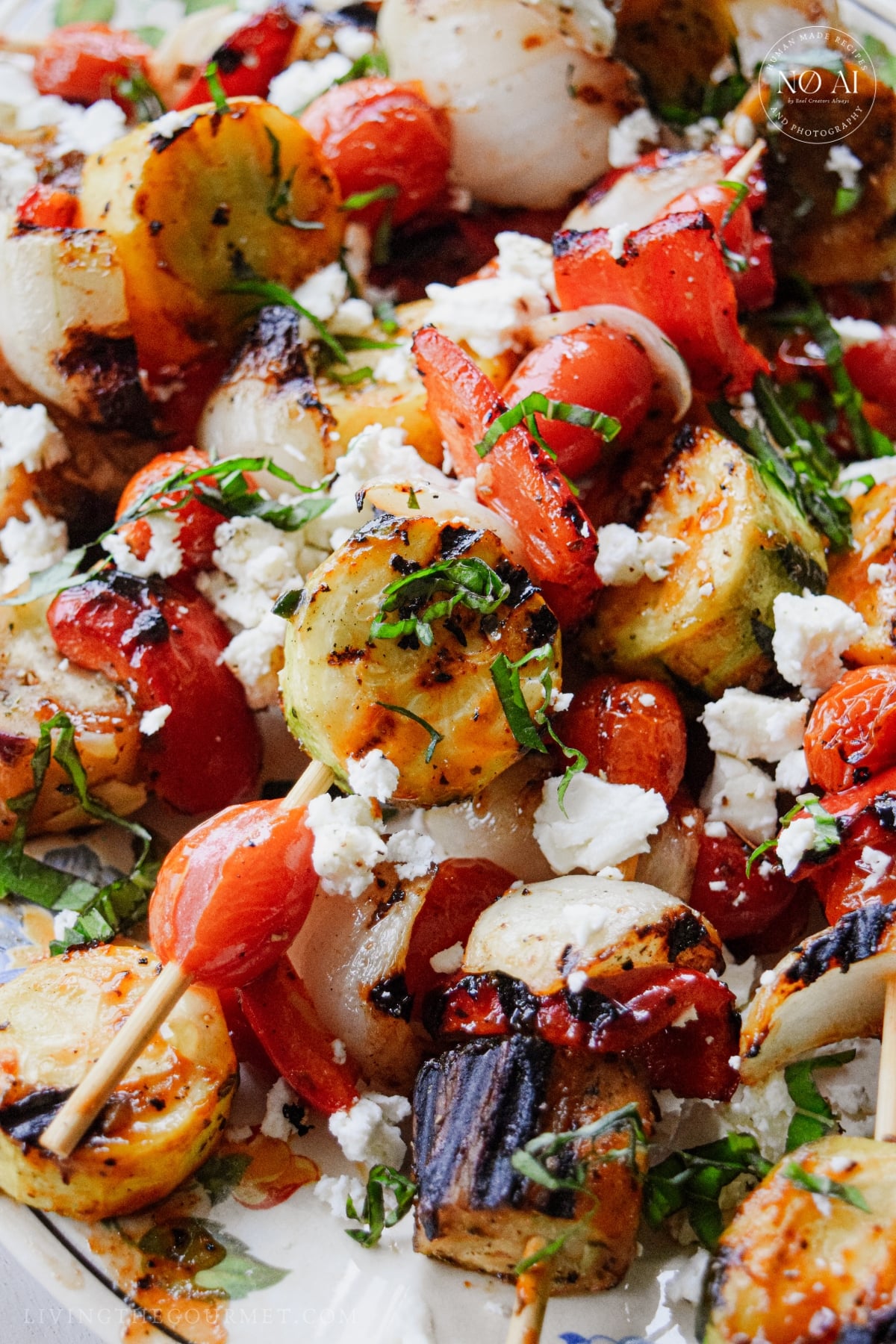 Grilled vegetable skewers for summer topped with marinated feta and garden basil.