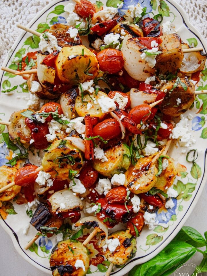 Griddle Vegetable Skewers Recipe with Marinated Feta plated for the summer dinner table.