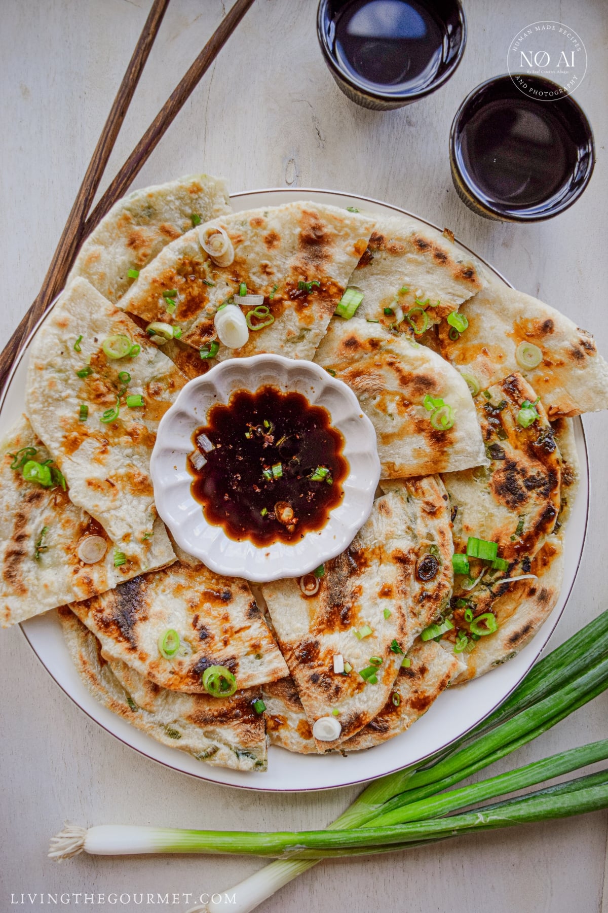 Golden scallion pancakes cut into wedges and arranged on a serving platter