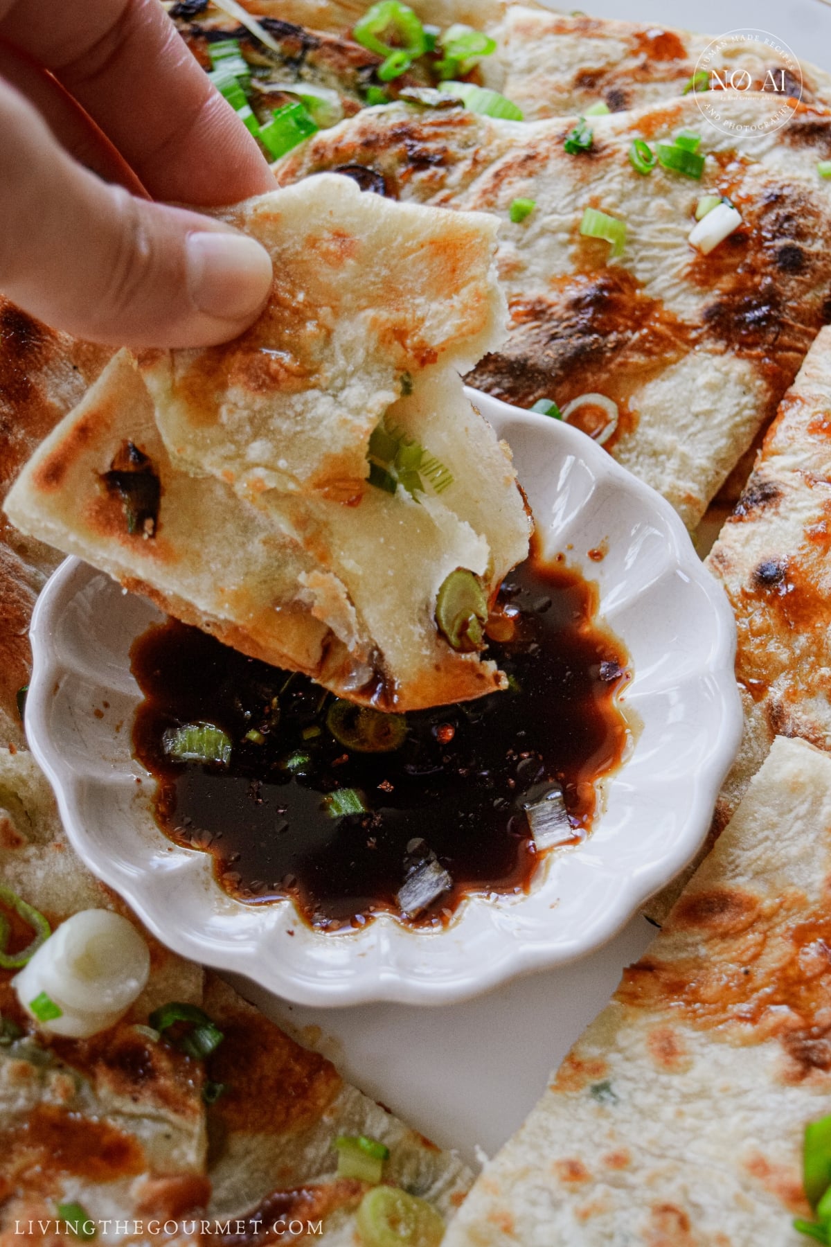 Soy sauce and chili crisp dipping sauce served with crispy scallion pancakes