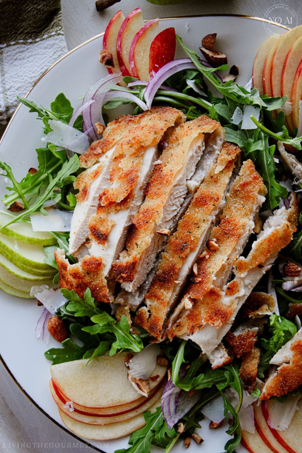 Golden pan-fried breaded chicken cutlets sliced over a fresh bed of arugula, sliced pears, apples, red onions, and toasted almonds