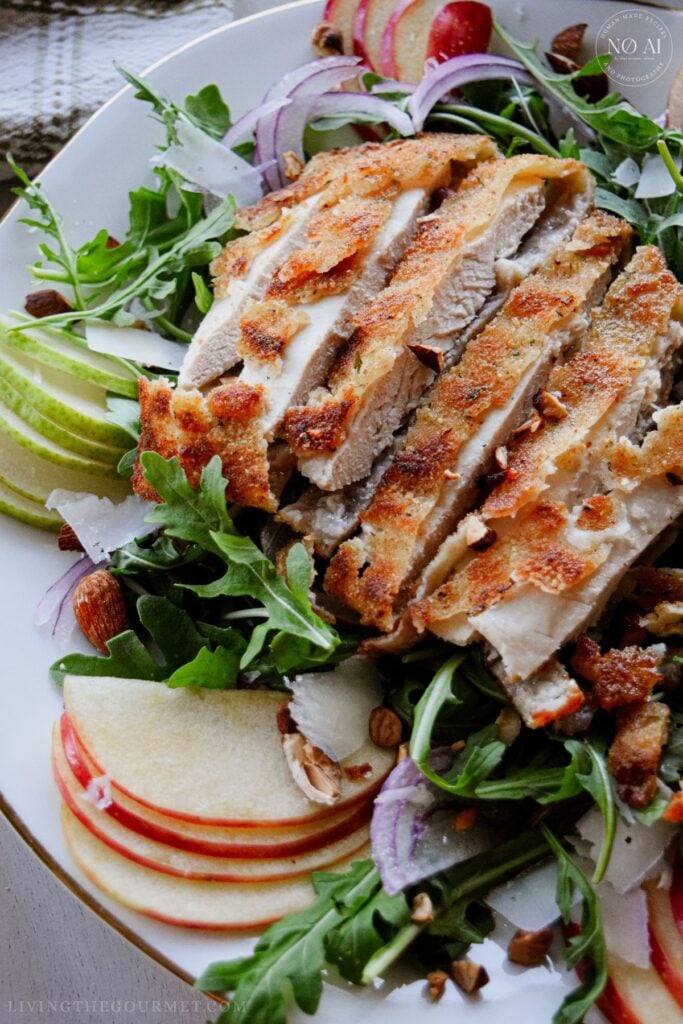 Golden pan-fried breaded chicken cutlets sliced over a fresh bed of arugula, sliced pears, apples, red onions, and toasted almonds