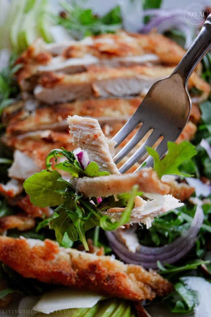 Golden pan-fried breaded chicken cutlets sliced over a fresh bed of arugula, sliced pears, apples, red onions, and toasted almonds