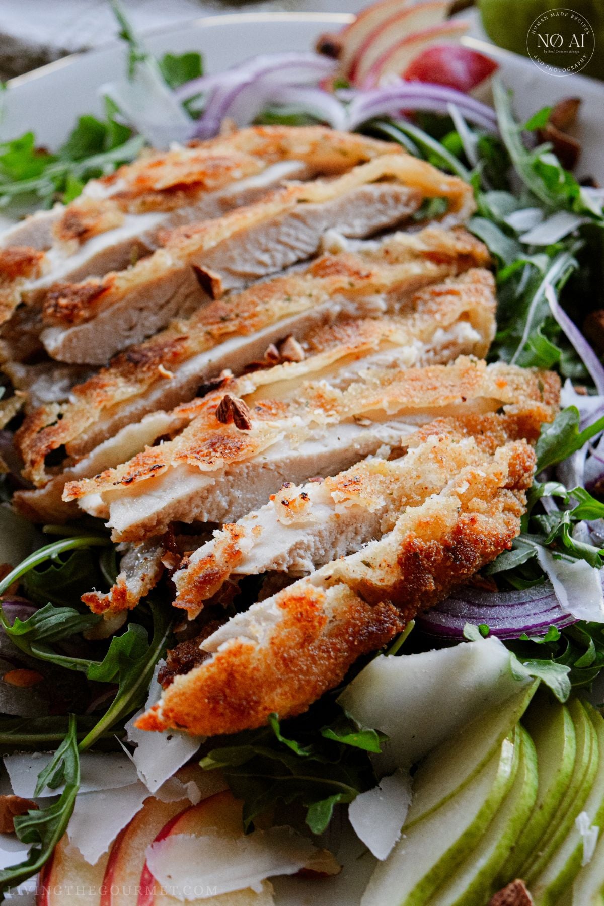 Golden pan-fried breaded chicken cutlets sliced over a fresh bed of arugula, sliced pears, apples, red onions, and toasted almonds